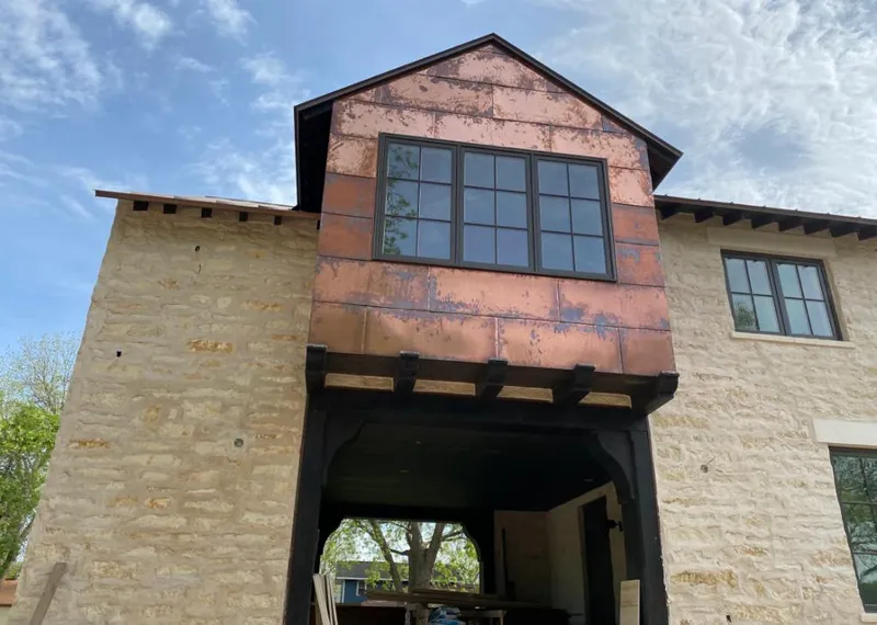 Copper metal panel facade on a stone building for Roof Repair in Collegedale